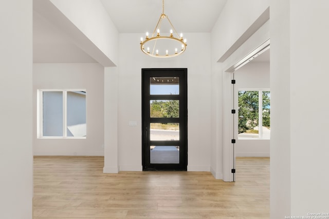 foyer with a notable chandelier and light hardwood / wood-style flooring