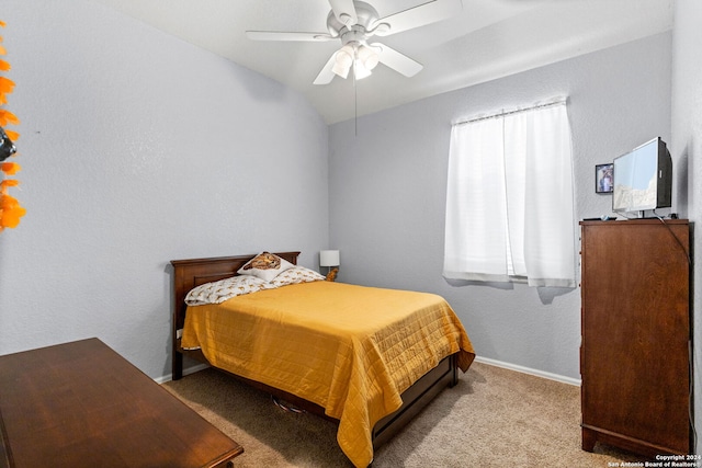 bedroom featuring light carpet, lofted ceiling, and ceiling fan