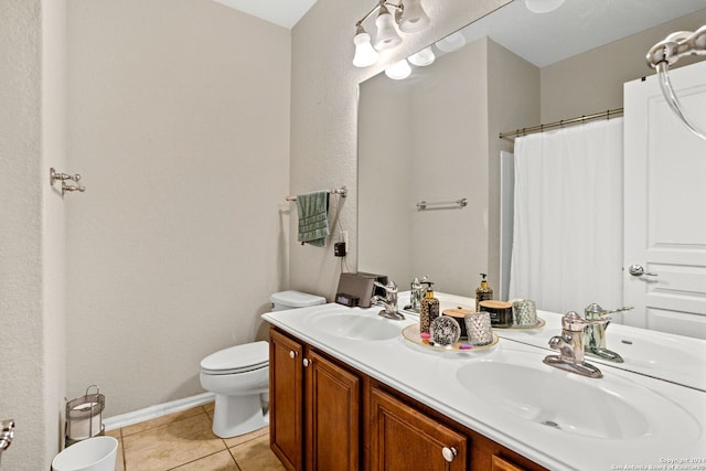 bathroom with walk in shower, vanity, tile patterned flooring, and toilet