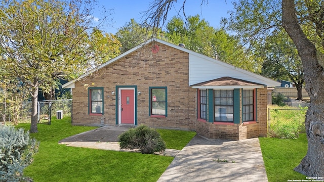 bungalow-style home with a front lawn