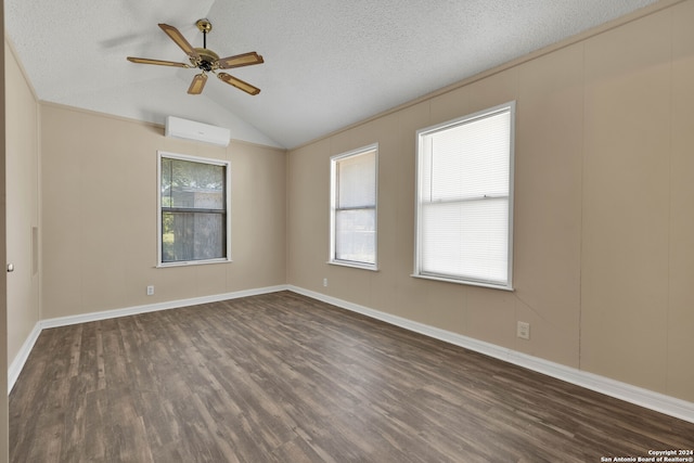 spare room with lofted ceiling, plenty of natural light, dark hardwood / wood-style flooring, and ceiling fan