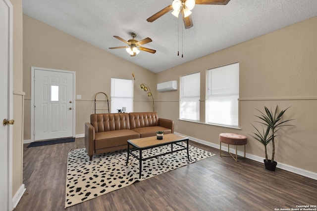 living room with ceiling fan, dark hardwood / wood-style floors, an AC wall unit, vaulted ceiling, and a textured ceiling