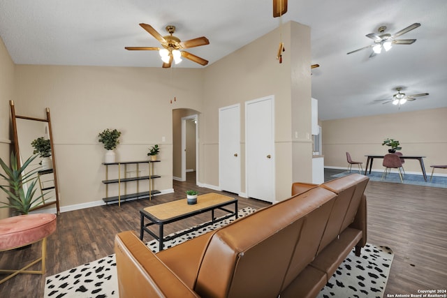 living room featuring dark wood-type flooring and vaulted ceiling