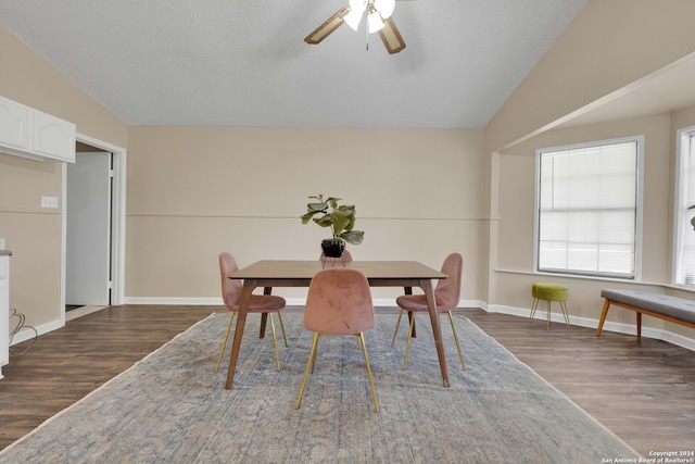 dining space featuring ceiling fan, a textured ceiling, dark hardwood / wood-style floors, and vaulted ceiling