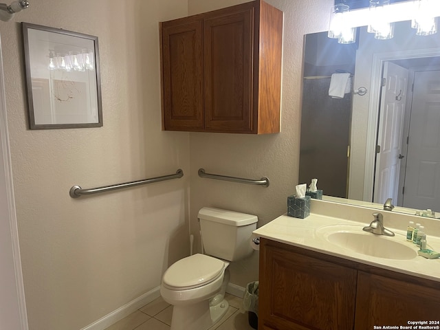 bathroom with tile patterned flooring, vanity, and toilet