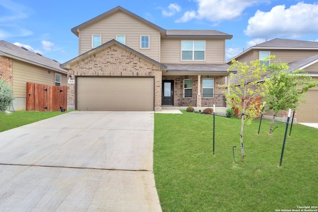 view of front of home featuring a garage, a porch, and a front lawn