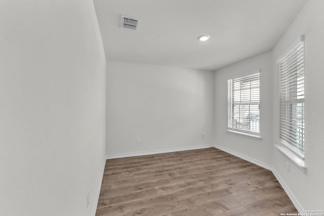 spare room featuring light hardwood / wood-style flooring