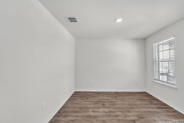 spare room with hardwood / wood-style flooring