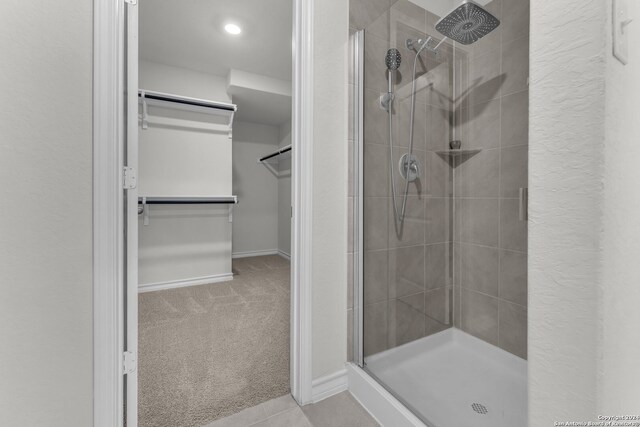 bathroom featuring a shower with door