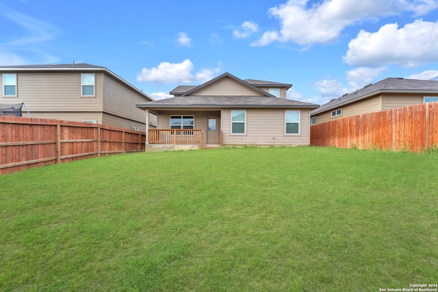 rear view of property with a lawn