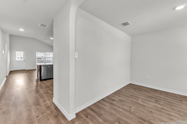 interior space featuring lofted ceiling and wood-type flooring