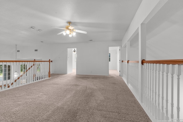 unfurnished room with carpet flooring and ceiling fan