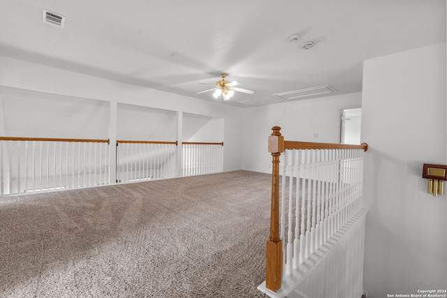 empty room featuring carpet floors and ceiling fan