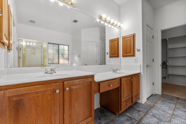full bathroom featuring visible vents, a sink, a stall shower, and double vanity