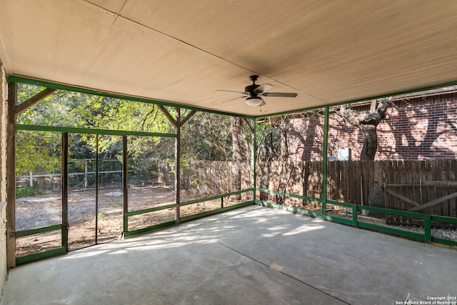 unfurnished sunroom featuring ceiling fan