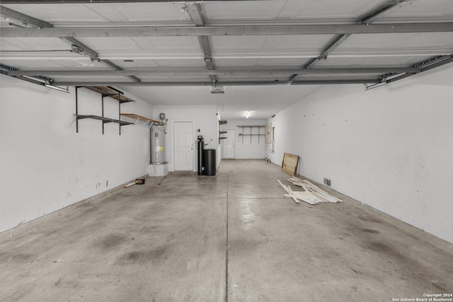 garage featuring water heater and a garage door opener