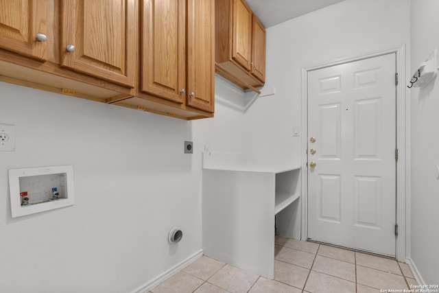 clothes washing area featuring washer hookup, cabinets, light tile patterned floors, and electric dryer hookup