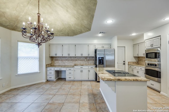 kitchen featuring light stone countertops, a center island, white cabinets, hanging light fixtures, and appliances with stainless steel finishes