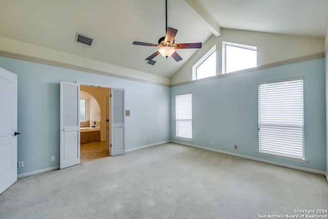 interior space featuring ceiling fan, connected bathroom, beam ceiling, high vaulted ceiling, and light colored carpet