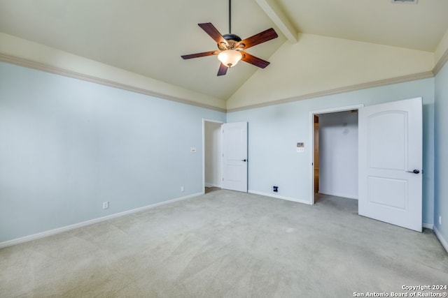 unfurnished bedroom with light carpet, beam ceiling, high vaulted ceiling, and ceiling fan