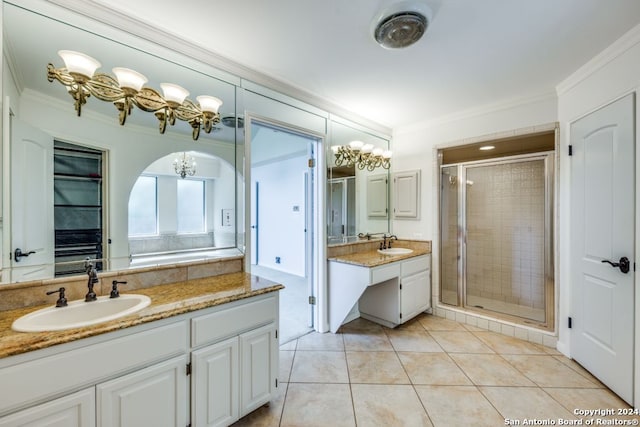 bathroom featuring tile patterned floors, crown molding, vanity, and a shower with shower door