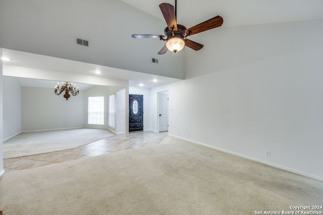 unfurnished living room featuring light carpet, ceiling fan with notable chandelier, and high vaulted ceiling