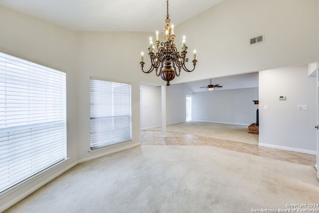 carpeted spare room featuring an inviting chandelier, ornate columns, and high vaulted ceiling