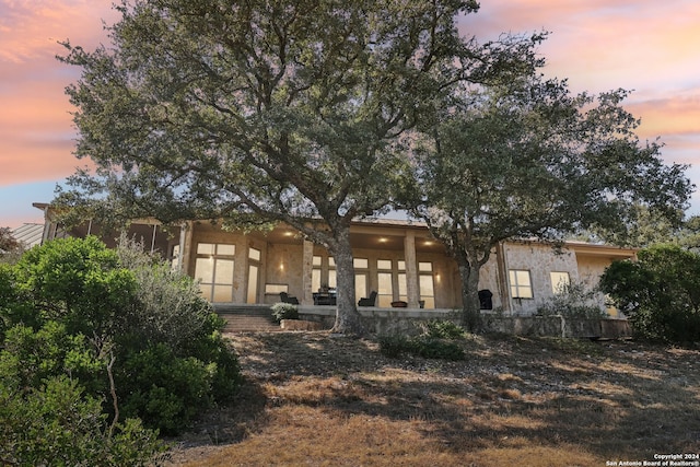 view of back house at dusk