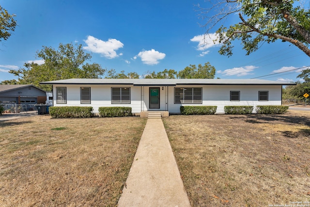 ranch-style home with a front lawn