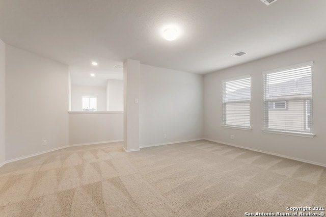 empty room featuring light colored carpet