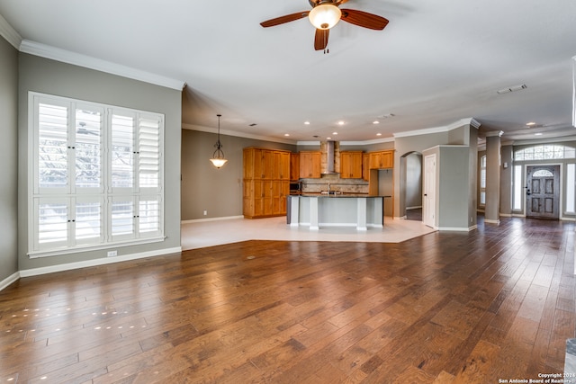 unfurnished living room with ceiling fan, light wood-type flooring, and crown molding