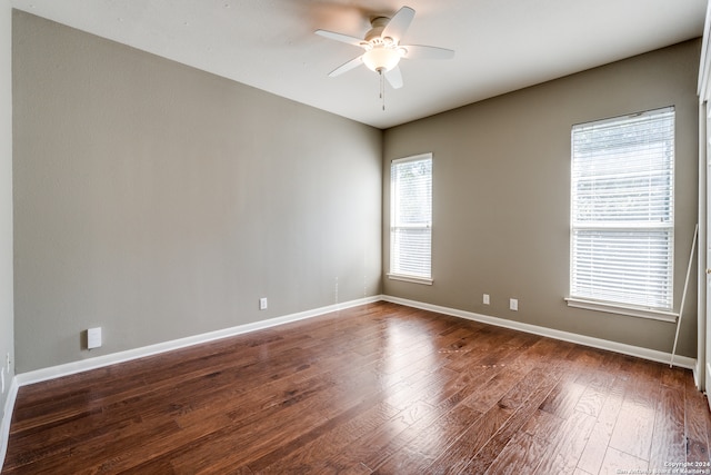 spare room featuring ceiling fan and dark hardwood / wood-style floors