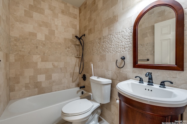 full bathroom with tile walls, tiled shower / bath combo, toilet, and tasteful backsplash