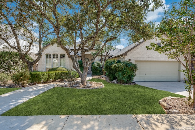 view of front of property with a front lawn and a garage