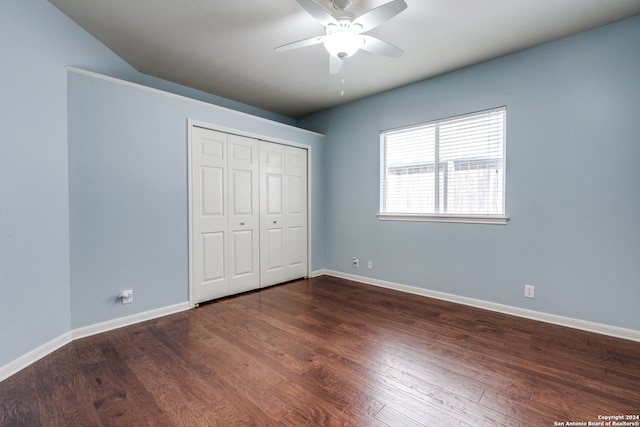 unfurnished bedroom featuring dark hardwood / wood-style flooring, a closet, and ceiling fan