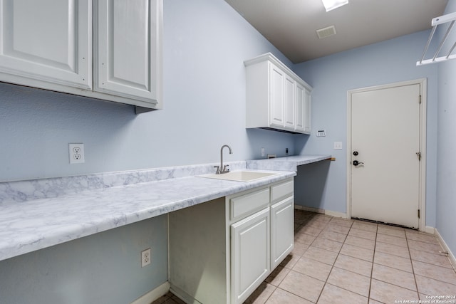 laundry room with sink, washer hookup, cabinets, hookup for an electric dryer, and light tile patterned flooring