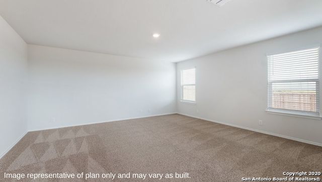 spare room featuring light colored carpet