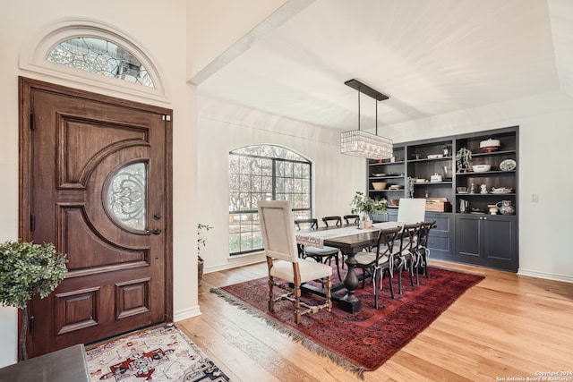 dining area with light hardwood / wood-style flooring and a healthy amount of sunlight