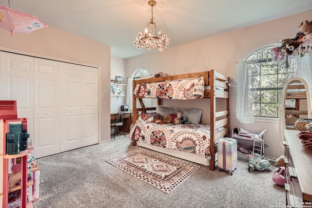 carpeted bedroom featuring a notable chandelier and a closet