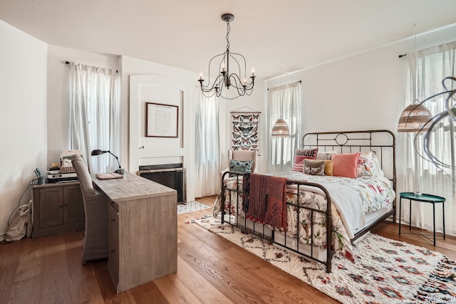 bedroom featuring a notable chandelier and wood-type flooring