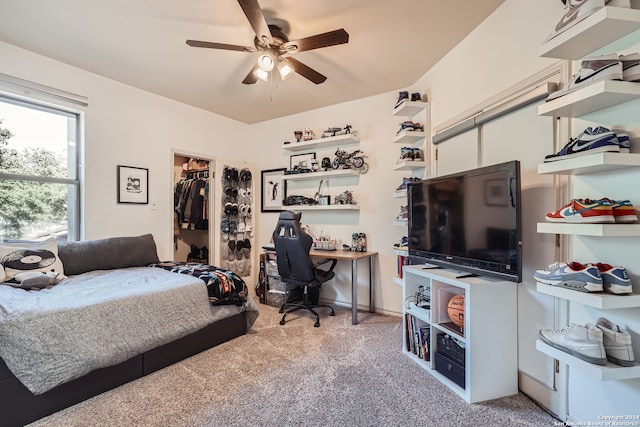 carpeted bedroom featuring a closet, a spacious closet, and ceiling fan