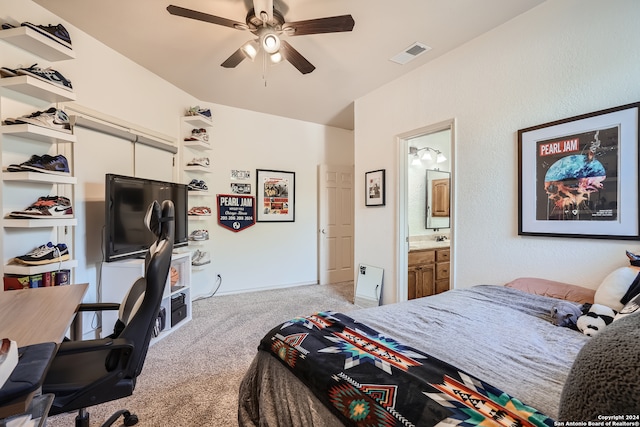 carpeted bedroom with ensuite bathroom and ceiling fan