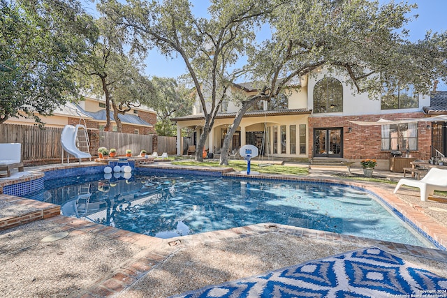 view of pool featuring a patio and a water slide