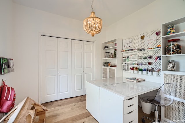 home office featuring light hardwood / wood-style flooring and a notable chandelier