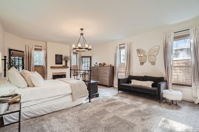 bedroom with carpet, a notable chandelier, and multiple windows