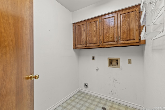 clothes washing area with hookup for a washing machine, gas dryer hookup, hookup for an electric dryer, and cabinets