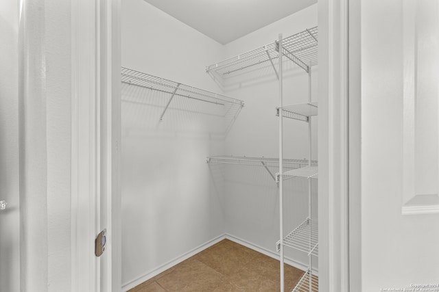 spacious closet featuring tile patterned floors