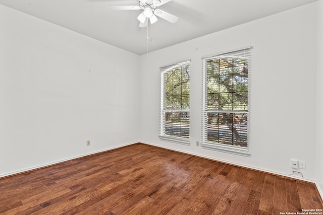 spare room with ceiling fan and hardwood / wood-style flooring