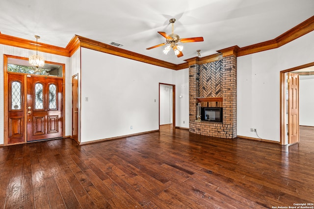 unfurnished living room with ceiling fan with notable chandelier, a fireplace, crown molding, and dark hardwood / wood-style flooring