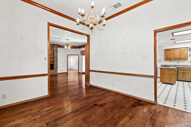 empty room featuring ceiling fan with notable chandelier, ornamental molding, and dark hardwood / wood-style flooring